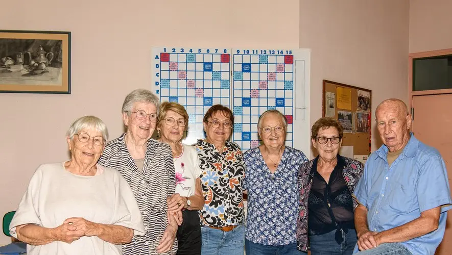 cop-s Groupe de personnes âgées posant devant un tableau de mots croisés